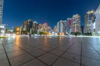 large, urban area in a very wide cityscape at night, with skyscrapers lit up in the distance