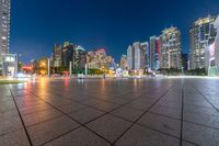 large, urban area in a very wide cityscape at night, with skyscrapers lit up in the distance