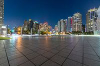 large, urban area in a very wide cityscape at night, with skyscrapers lit up in the distance