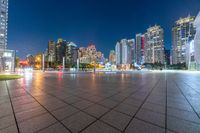 large, urban area in a very wide cityscape at night, with skyscrapers lit up in the distance