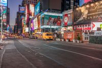 a busy city at night time with the motion bluring of the taxi and billboards