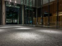 an open door at the lobby of a modern building with glass doors on either side