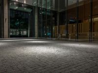 an open door at the lobby of a modern building with glass doors on either side