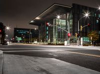 traffic lights and buildings are lit up at night time in the city square area of this area