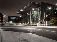 traffic lights and buildings are lit up at night time in the city square area of this area