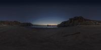 a picture taken with the 360 - angle lens at night of a scenic view of cliffs near a sea