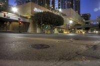 an empty city street with a building in the background at night with no people on it