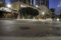 an empty city street with a building in the background at night with no people on it