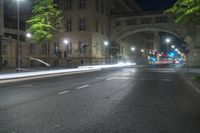 the car is driving on the road at night time near the city streets with lights