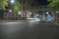 the car is driving on the road at night time near the city streets with lights