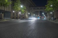 the car is driving on the road at night time near the city streets with lights