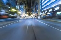 cars are driving in the city at night time as blurry image is taken from the inside of a car