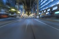 cars are driving in the city at night time as blurry image is taken from the inside of a car