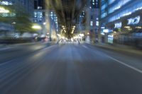 cars are driving in the city at night time as blurry image is taken from the inside of a car