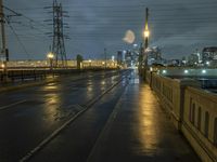 a night time scene of a flooded roadway with the lights on and dark and rainy sky