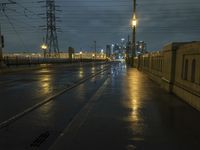 a night time scene of a flooded roadway with the lights on and dark and rainy sky