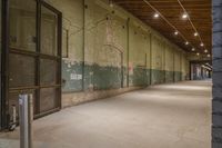 a car is parked next to the wall with graffiti on it at night in a parking garage