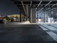 a modern building with the windows open and lights on at night time in the city