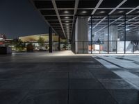 a modern building with the windows open and lights on at night time in the city