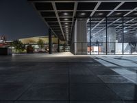 a modern building with the windows open and lights on at night time in the city