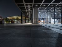 a modern building with the windows open and lights on at night time in the city