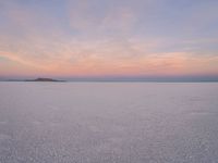 people skiing down the snow covered ground in the middle of nowhere or frozen lake ice