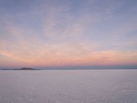 people skiing down the snow covered ground in the middle of nowhere or frozen lake ice