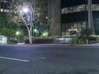 a man skateboarding at night on a city street in the middle of a city