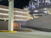 a view of a road and an overpass with traffic passing through it by buildings