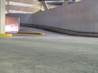 a view of a road and an overpass with traffic passing through it by buildings