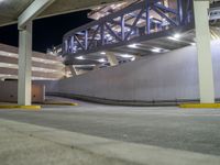 a view of a road and an overpass with traffic passing through it by buildings