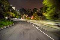 motion blurry image taken from a bus passing by at night with buildings in background