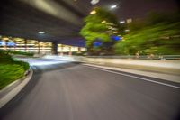 motion blurry image taken from a bus passing by at night with buildings in background