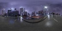 a street scene with buildings and buildings in the background at night time with an inverted lens