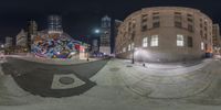 a person jumping on a skateboard with a building behind it at night, taken from a half pipe