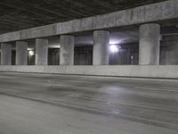 an empty parking garage with no people in it at night time time with only one stop sign