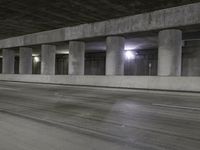 an empty parking garage with no people in it at night time time with only one stop sign