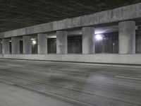 an empty parking garage with no people in it at night time time with only one stop sign