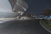 a photo taken at night with all lights on at the entrance to an building on a highway