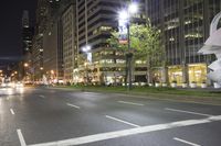 the city is lit up at night, but there is no traffic in sight for pedestrians