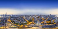 a long exposure photo of a busy city with multiple circles of light trails over buildings