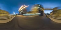 a blurry photo of an empty park area at night with blurred motion of buildings at dusk