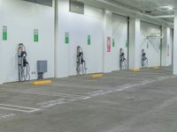 two parking spaces that have electric charging stations at each end of them in the building