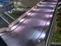 a view of a road and an overpass with traffic passing through it by buildings