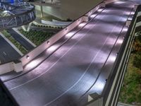 a view of a road and an overpass with traffic passing through it by buildings