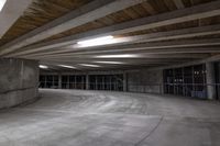 an empty parking garage has a lot of concrete walls and beams above the ceiling on top