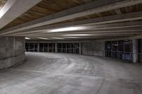 an empty parking garage has a lot of concrete walls and beams above the ceiling on top