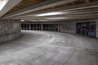 an empty parking garage has a lot of concrete walls and beams above the ceiling on top