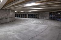 an empty parking garage has a lot of concrete walls and beams above the ceiling on top