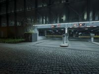 a parking lot with several signs lit up in the dark at night time's